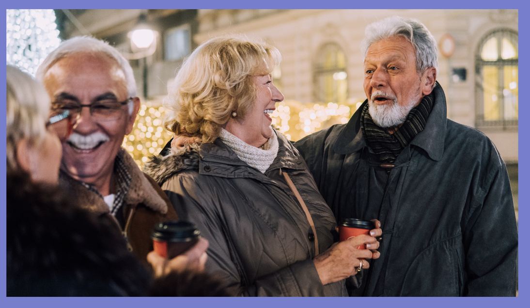 Photo of four happy older people in winter clothing chatting together